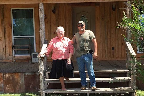 Audrey Sistrunk stands in front of her new home with its architect and builder, Ernest Thornhill.